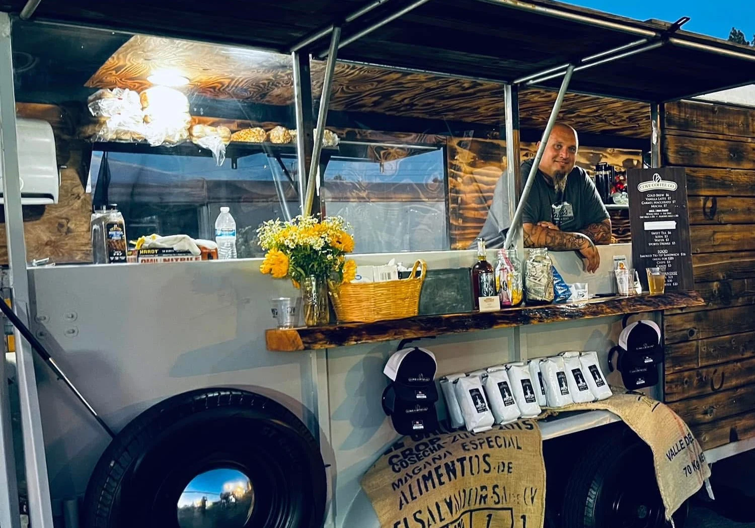 Eli at the serving window of his horse trailer converted into a kitchen